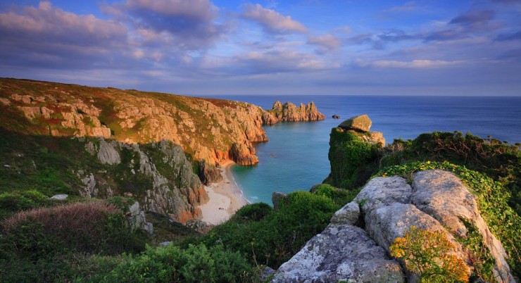 United Kingdom, UK, England, Cornwall, Penwith peninsula, Great Britain, Travel Destination, Coastal landscape near Porthcurno, with the National Trust owned Logan Rock, one of the iconic rock formations of Cornwall's Land's End Peninsula, in the background