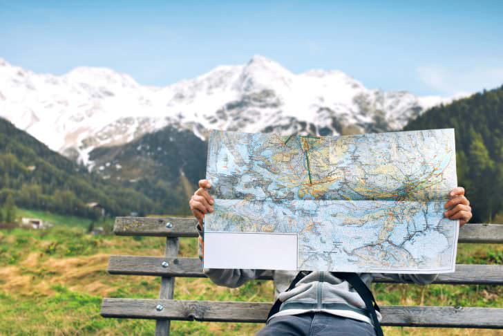 Hiker reading a geographic map