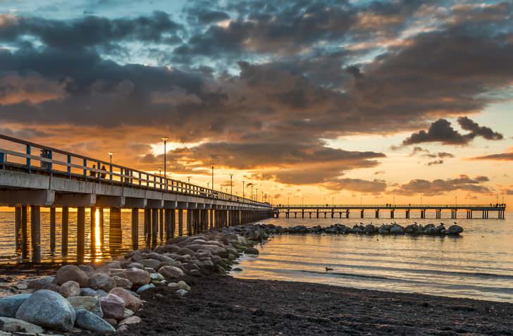Colorful sunset at a famous public marine berth in resort city of Palanga, Lithuania