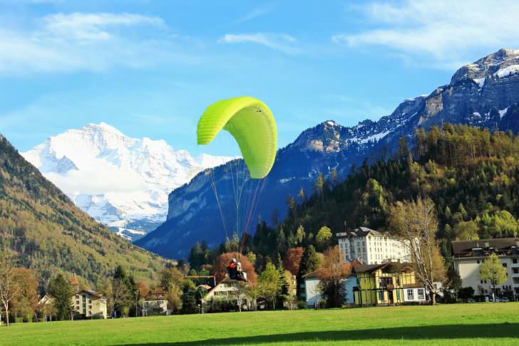 Man play para motor flying down in a garden, Interlaken, Switzerland