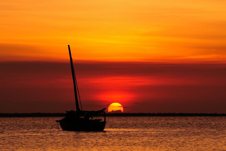 Fishermen Dhow Boat coming back home at sunset from a long day in the sea
