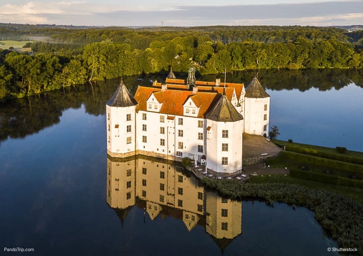 Aerial Drone View of Glucksburg water castle at dawn, Germany