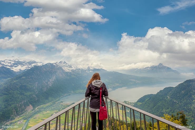 Woman looking to Interlaken panorama from viewpoint at Harder Kulm