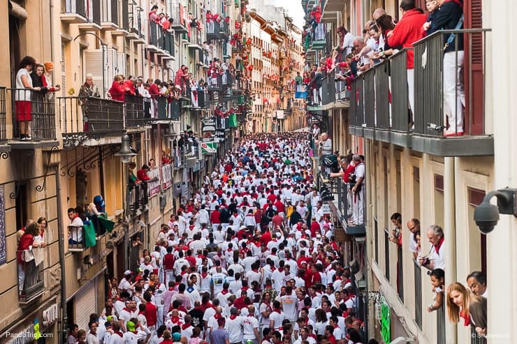 Bull running in the calle Estafeta in Pamplona, Spain