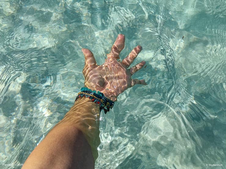 Hand under the crystal clear water, Jervis Bay, Australia