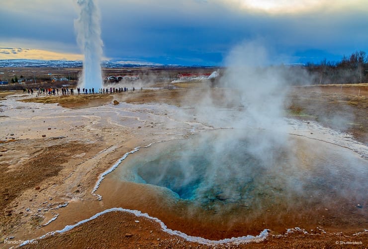 Blue pool with the Strokkur Geyser in Iceland