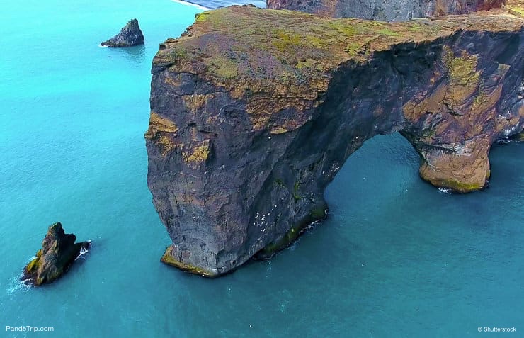 Huge Sea Arch In Turquoise Blue Ocean. Dyrholaey Sea Arch in Iceland