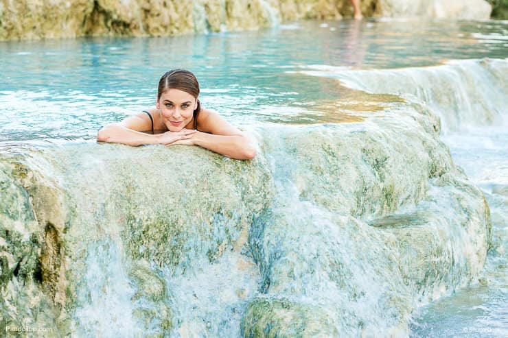 Woman enjoying Cascate del Mulino, Saturnia, Italy