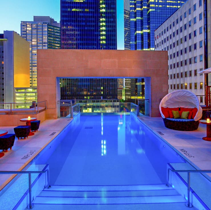 Glass-fronted rooftop pool in Dallas at night