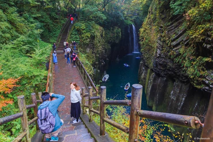 People are taking a photo at Takachiho Gorge, Japan