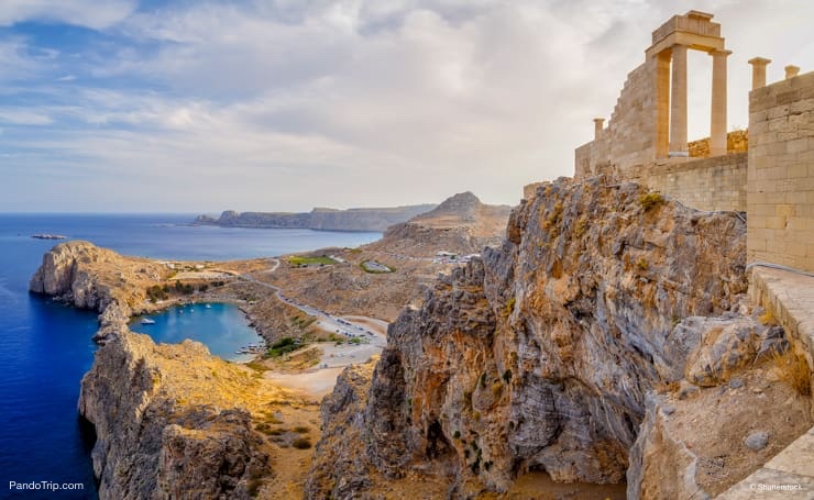 Acropolis of Lindos. Doric columns of the ancient Temple of Athena and the bay of St. Paul. Lindos, Rhodes, Greece