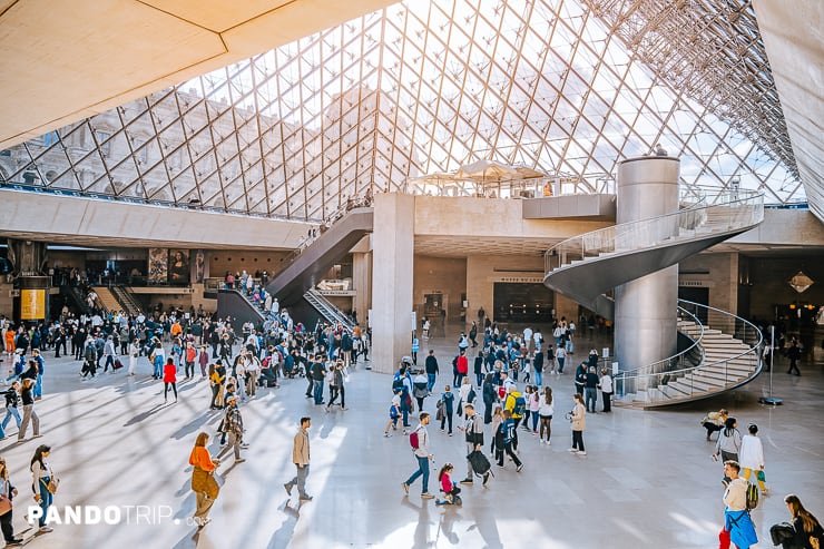 Entrance hall under the glass pyramid of Louvre Museum