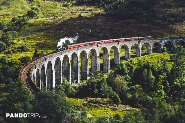Hogwarts Express passes Glenfinnan viaduct, Scottish Highlands