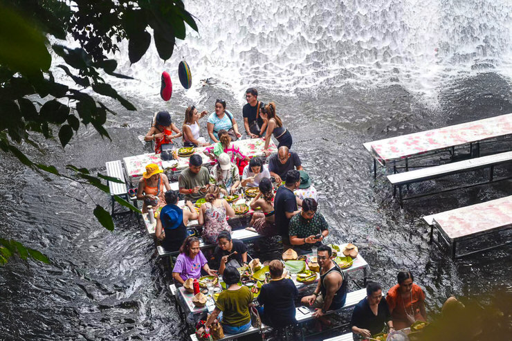 People dining at Labasin Waterfall Restaurant, Philippines
