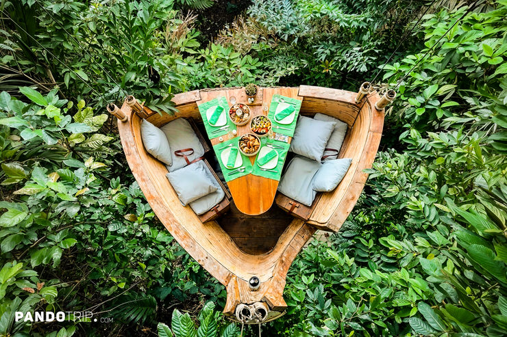 Top view of of a dining pod at Bird's Nest Restaurant in Thailand nestled among lush tropical greenery