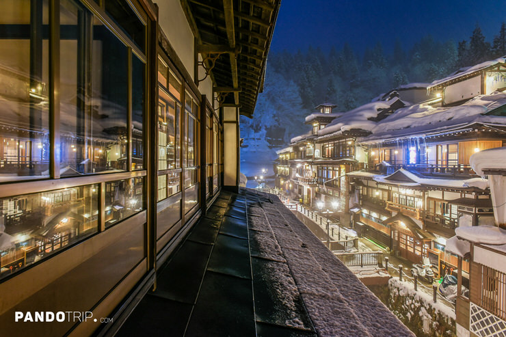 A view from a ryokan window overlooking the beautifully lit Ginzan Onsen
