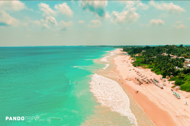 Spacious pink sandy beach in the Bahamas, green turquoise