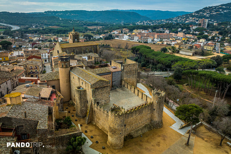 Aerial view of Calonge Castle (Castell de Calonge) with its fortified walls, round towers, and inner courtyard