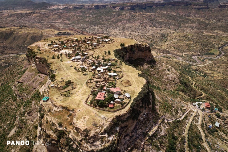 Top-down aerial shot of Debre Damo’s monastery complex and surrounding village on a high plateau