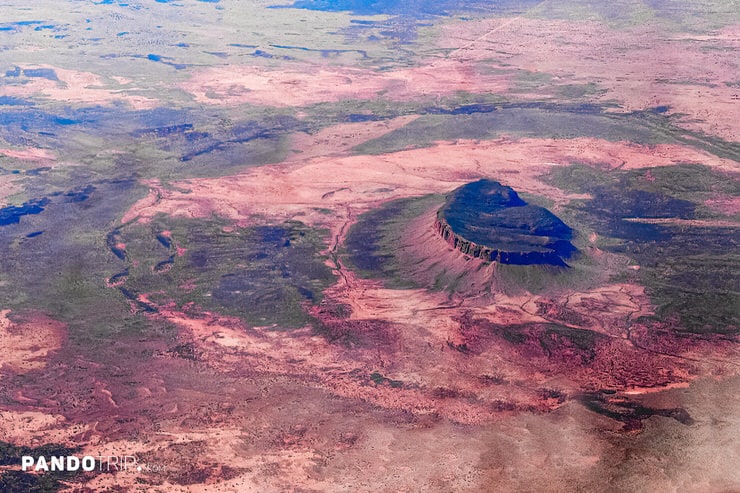 Aerial photo of Mount Conner showing its circular plateau and surrounding Outback terrain