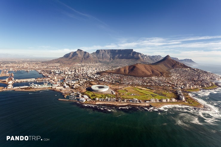 Panoramic aerial view of Table Mountain, Cape Town Stadium, and cityscape along South Africa's coastline