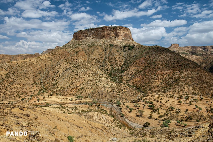 Debre Damo’s flat-topped mountain surrounded by rugged terrain in northern Ethiopia`