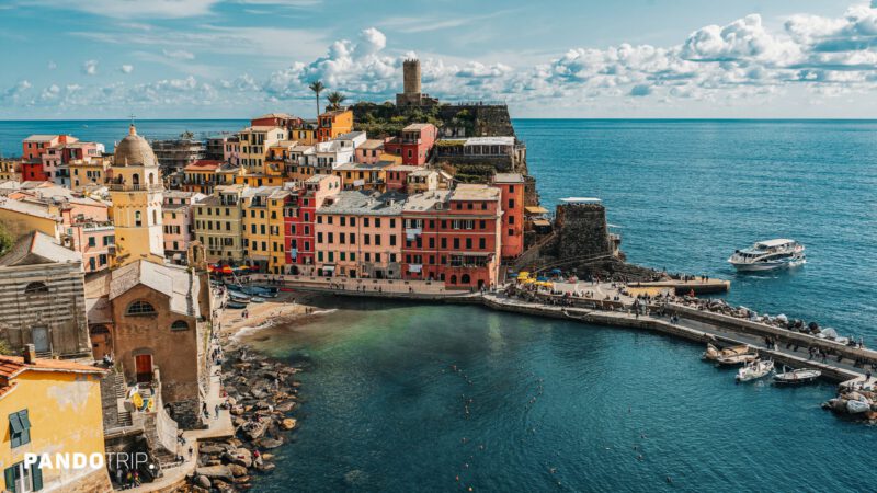 View of Vernazza’s harbor, bell tower, and waterfront buildings beside the sea