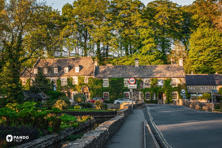 Swan Hotel Bibury at golden hour with ivy lit by evening sun