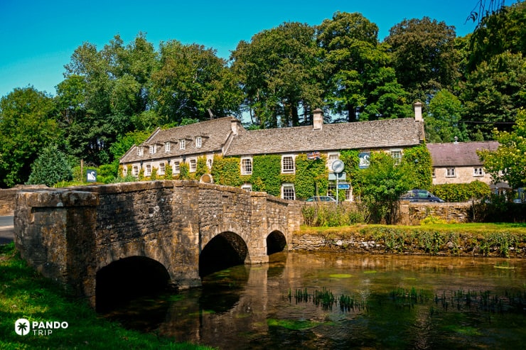 The Swan Hotel and 17th-century stone bridge over the River Coln in Bibury