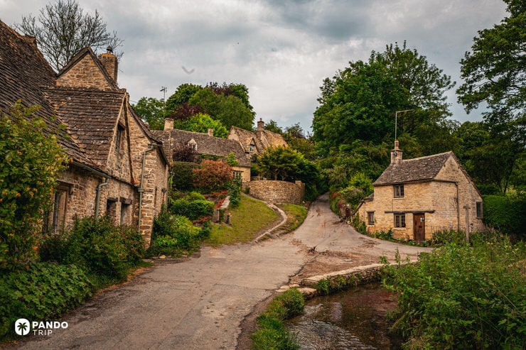 Uphill lane and stone cottages on Awkward Hill Bibury