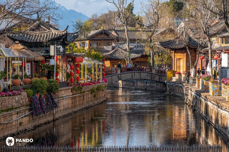 Charming canal-side view in Lijiang Old Town with red lanterns, bridges, and tea houses