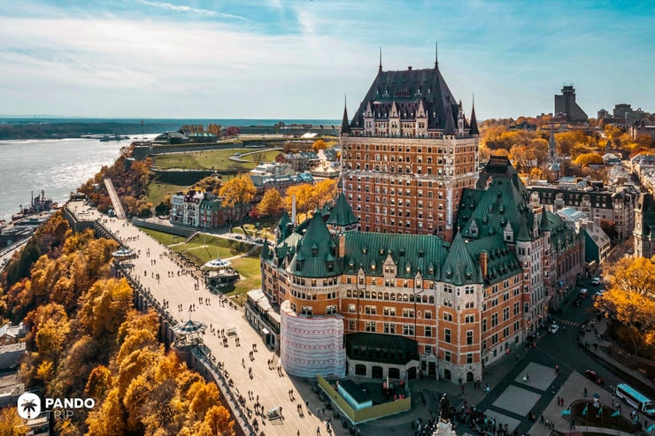 Château Frontenac seen from above in autumn, overlooking the St. Lawrence River and Old Quebec promenade