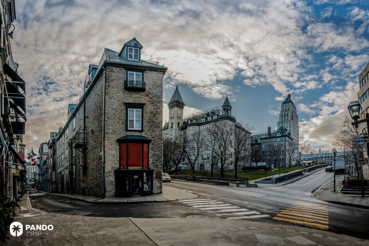 Stone buildings along Côte de la Fabrique in Old Quebec under dramatic skies