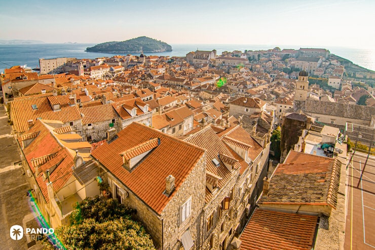 Scenic panoramic view of Dubrovnik’s terracotta rooftops and Lokrum Island in the Adriatic Sea