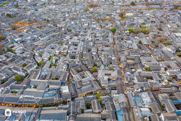 Drone view of Lijiang Old Town’s dense rooftops and narrow traditional alleyways