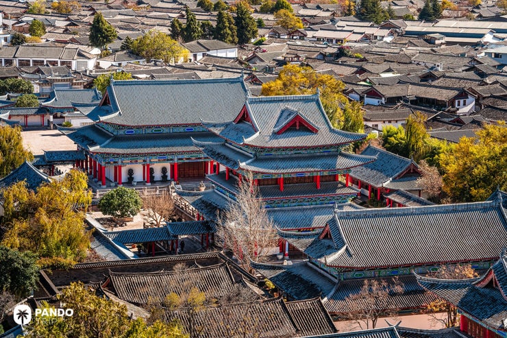 Ancient Chinese palace architecture of Mu Residence surrounded by Lijiang’s tiled rooftops