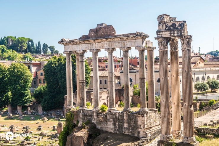 Ancient Roman temple columns surrounded by ruins in the Roman Forum