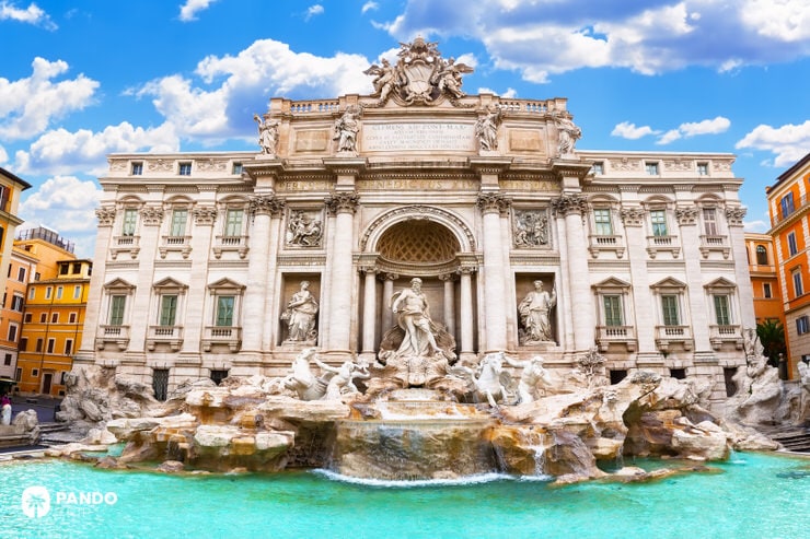 The iconic Trevi Fountain with sculptures and turquoise water in bright daylight