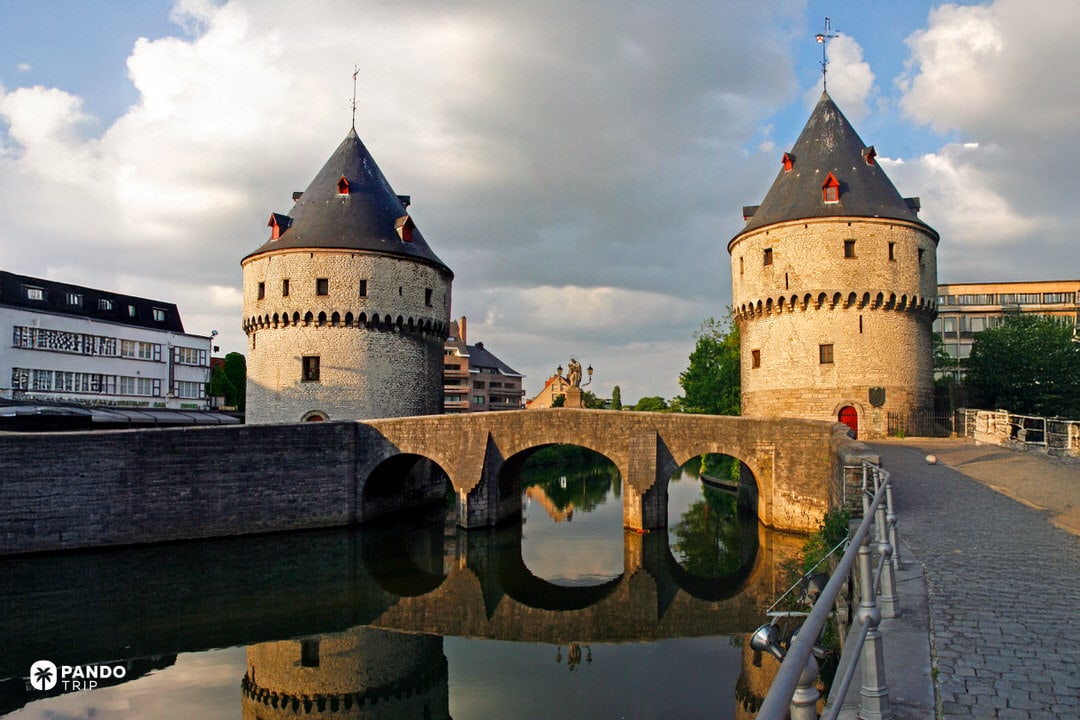The Broel Towers connected by a stone bridge over the River Leie in Kortrijk
