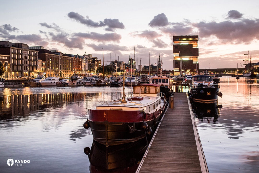Sunset at Antwerp’s Eilandje harbour with boats and the MAS Museum aan de Stroom