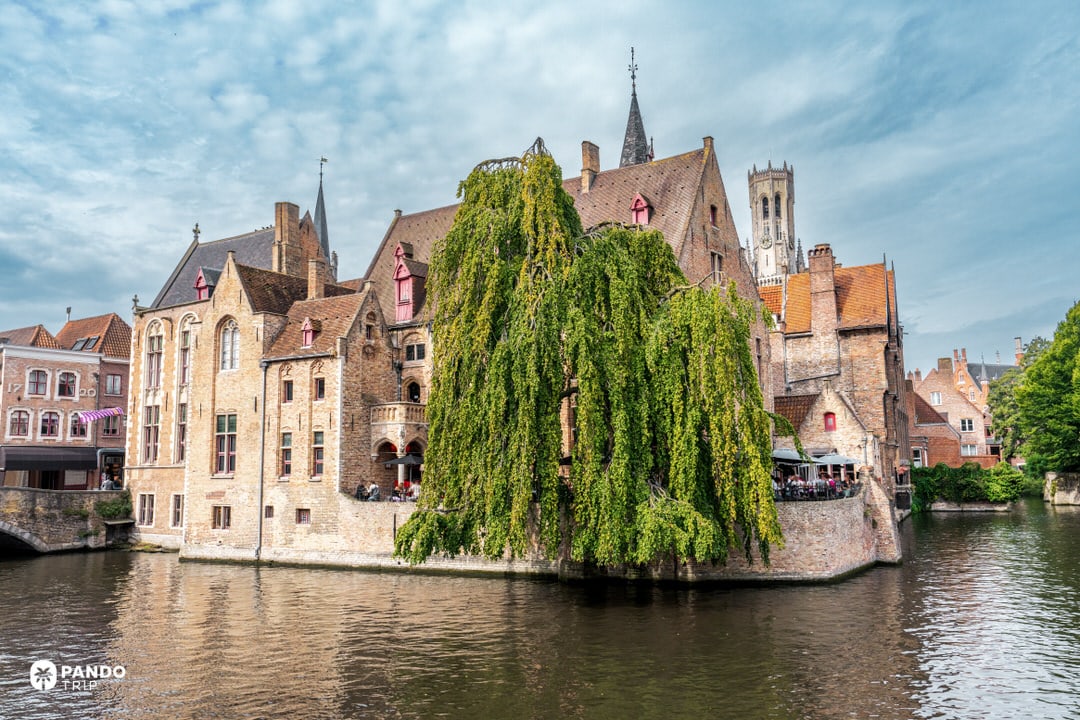 Iconic Rozenhoedkaai canal view with the Belfry of Bruges in the background