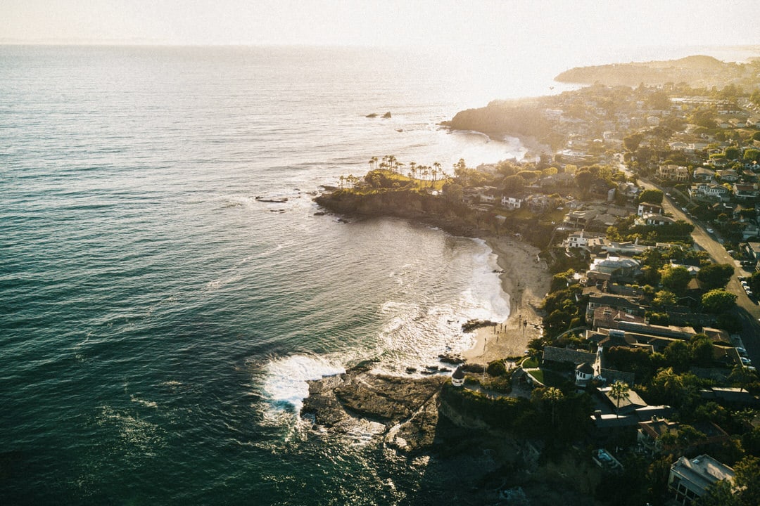 Aerial view of Heisler Park and Picnic Beach in Laguna Beach featuring the white gazebo and rocky coves.