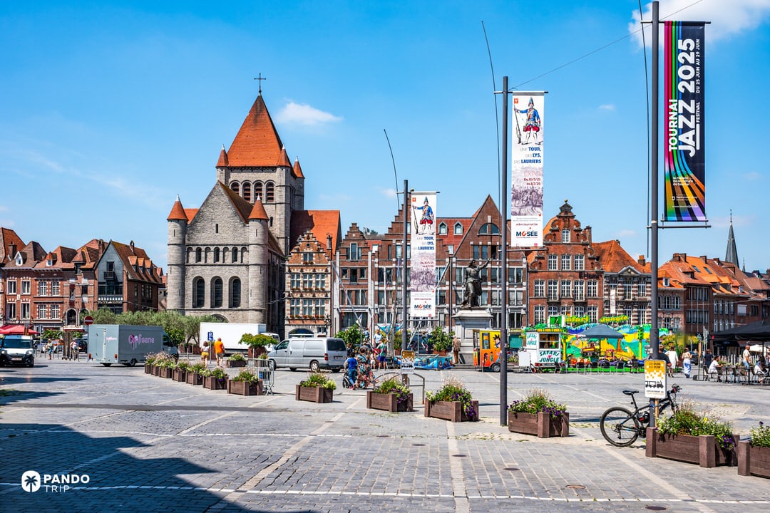 Grand-Place of Tournai with the Romanesque Saint-Quentin Church and red-tiled roofs