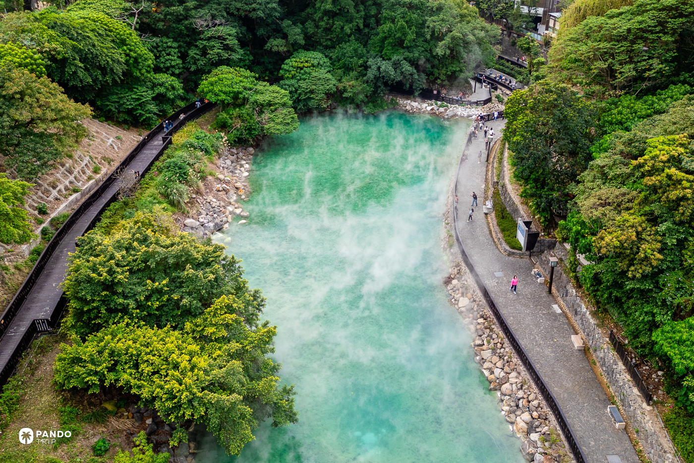Elevated view of Beitou Thermal Valley's steaming green pool with walkways along both banks.