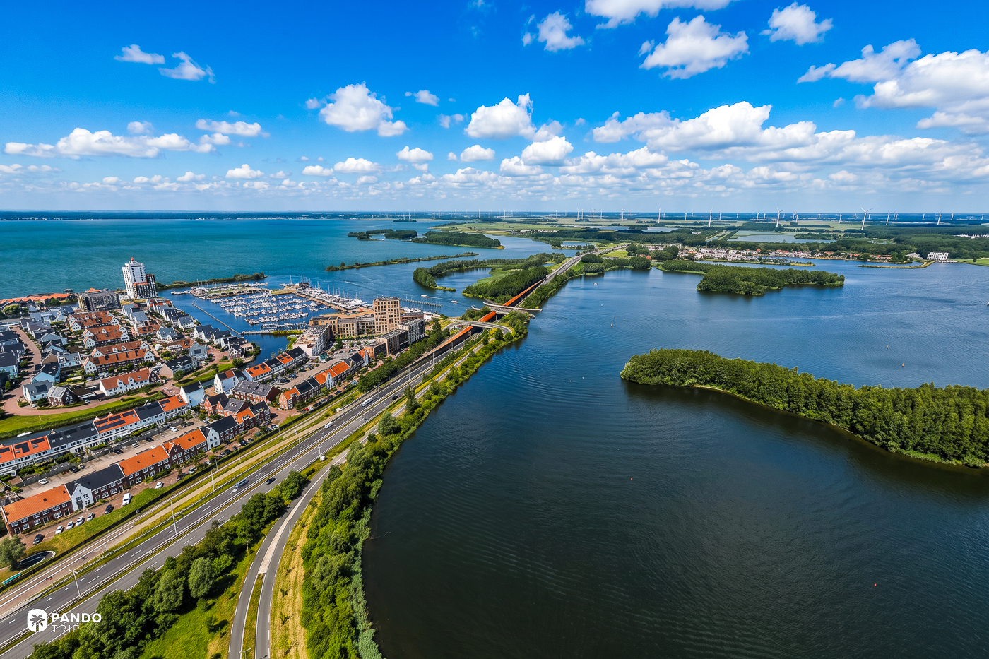 Aerial view of the Harderwijk waterfront and marina on the Veluwemeer, the N302 running north out of town toward the aqueduct.
