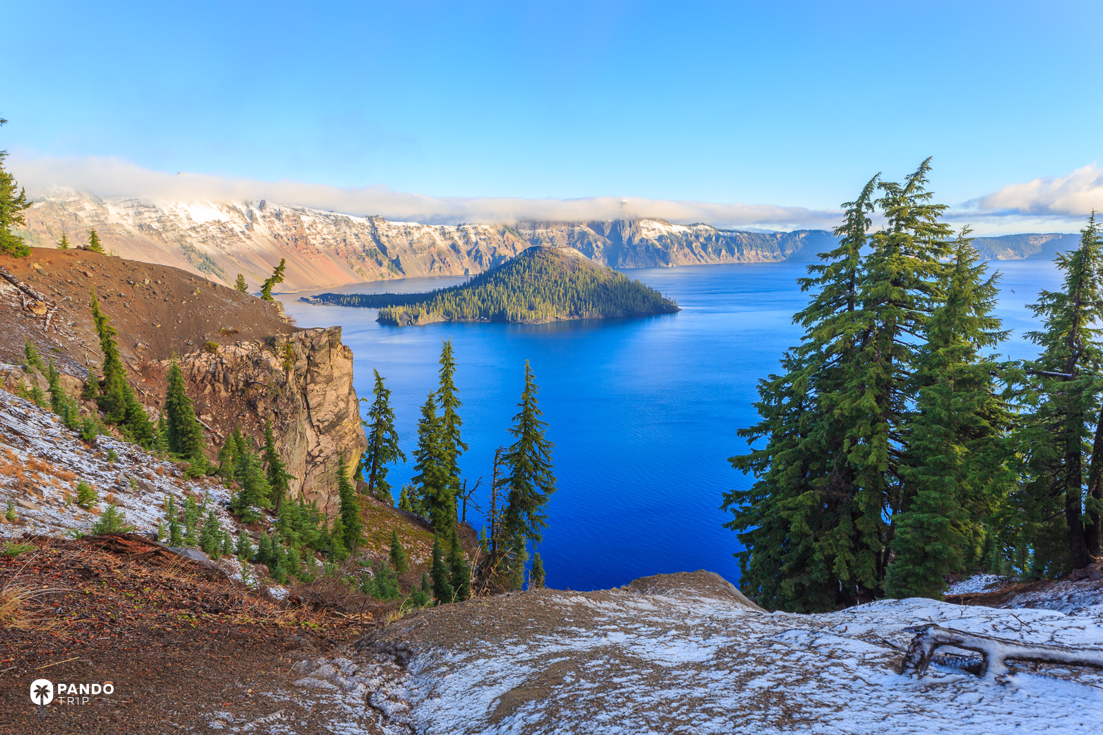 Wizard Island and the snow-covered caldera rim of Crater Lake, Oregon.
