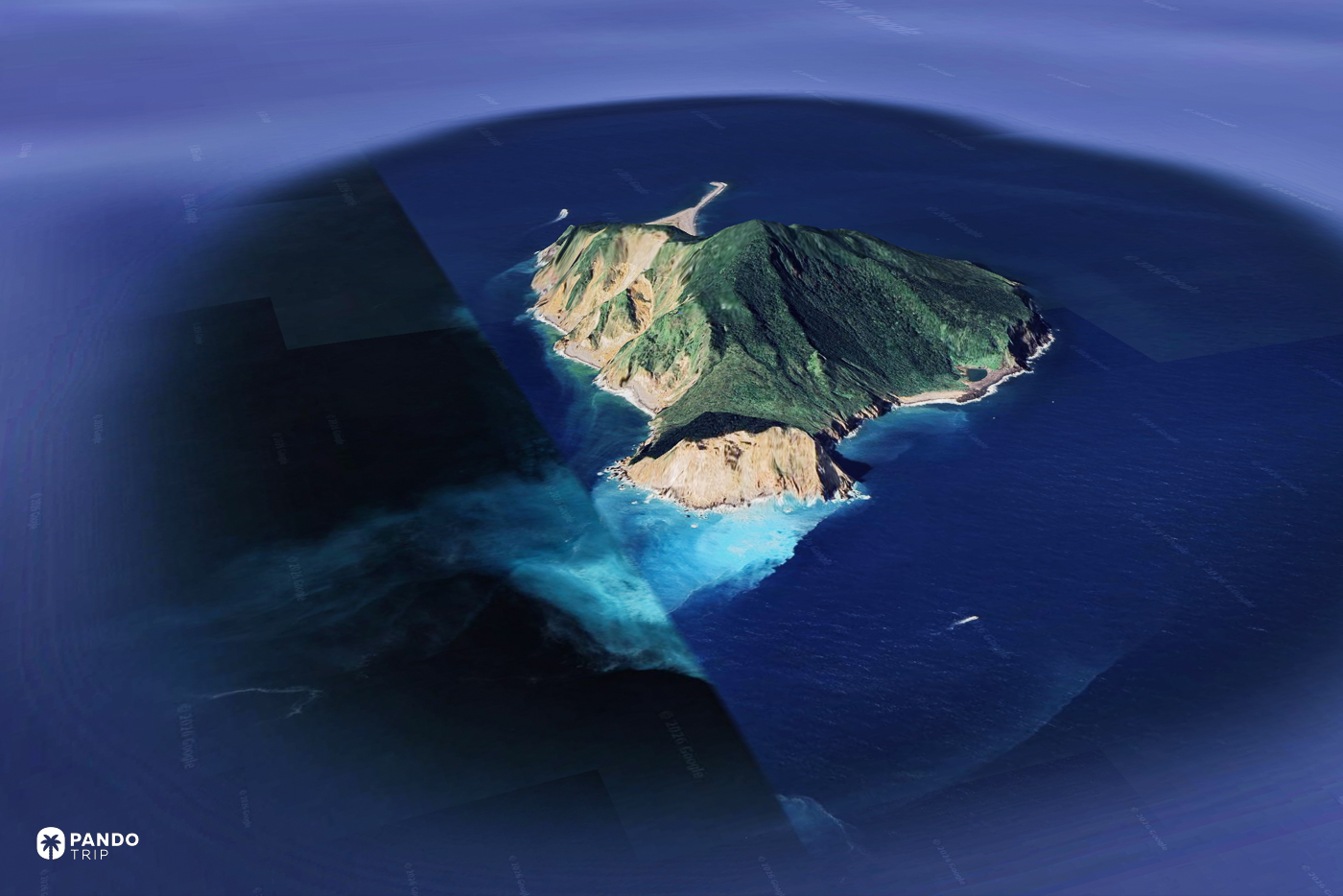 Satellite view of Guishan Island off Taiwan, a pale sulphur plume spreading from its cliffs into dark blue sea.