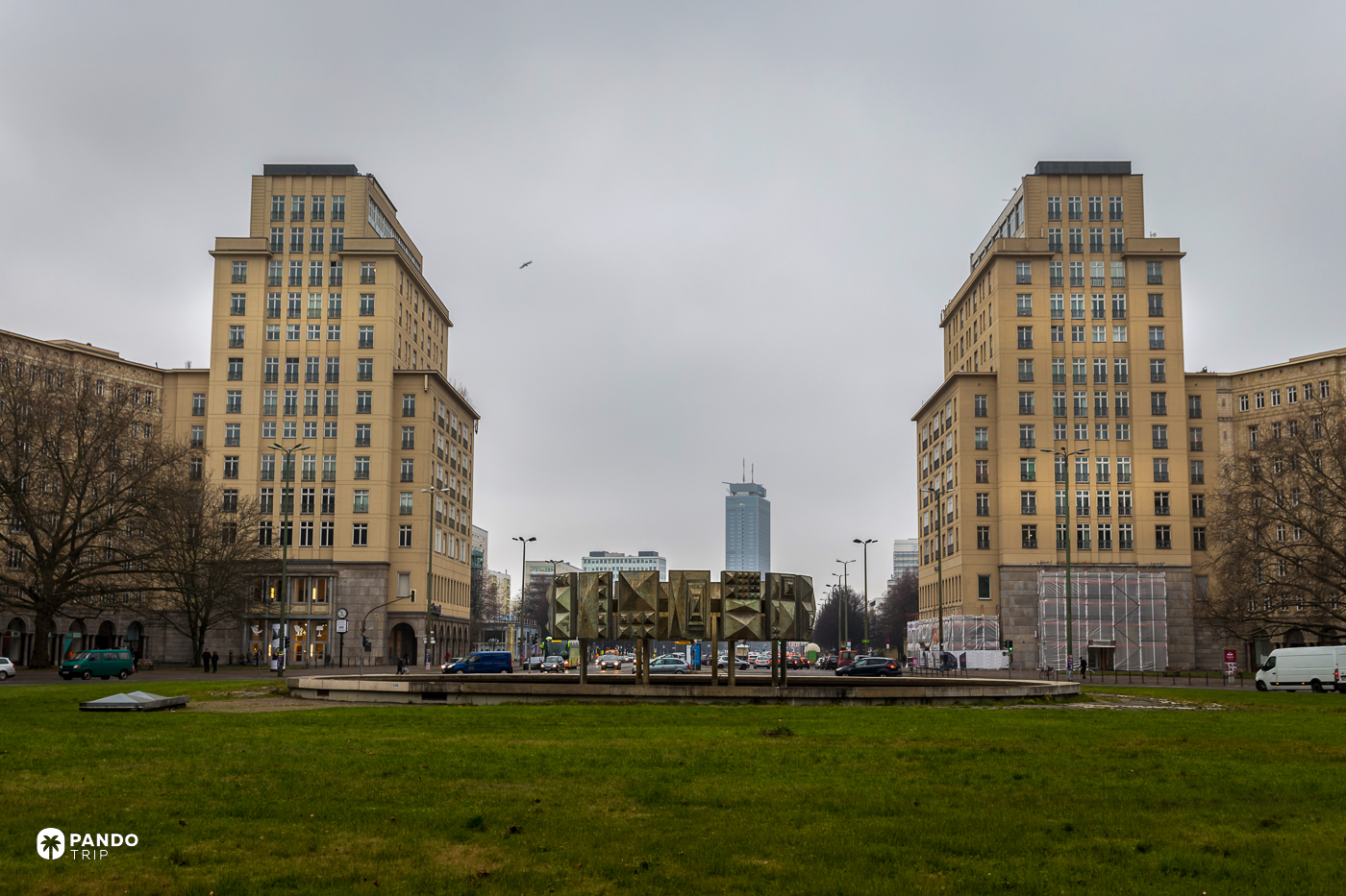 The twin tower blocks at Strausberger Platz on Karl-Marx-Allee under a grey Berlin sky.