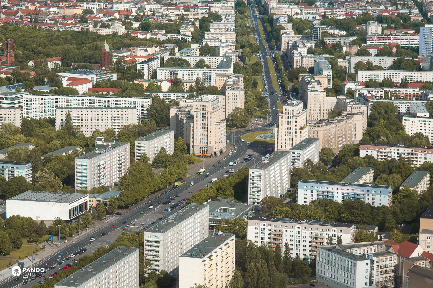 Karl-Marx-Allee seen from above, running between its tiled blocks and postwar slabs across Friedrichshain.