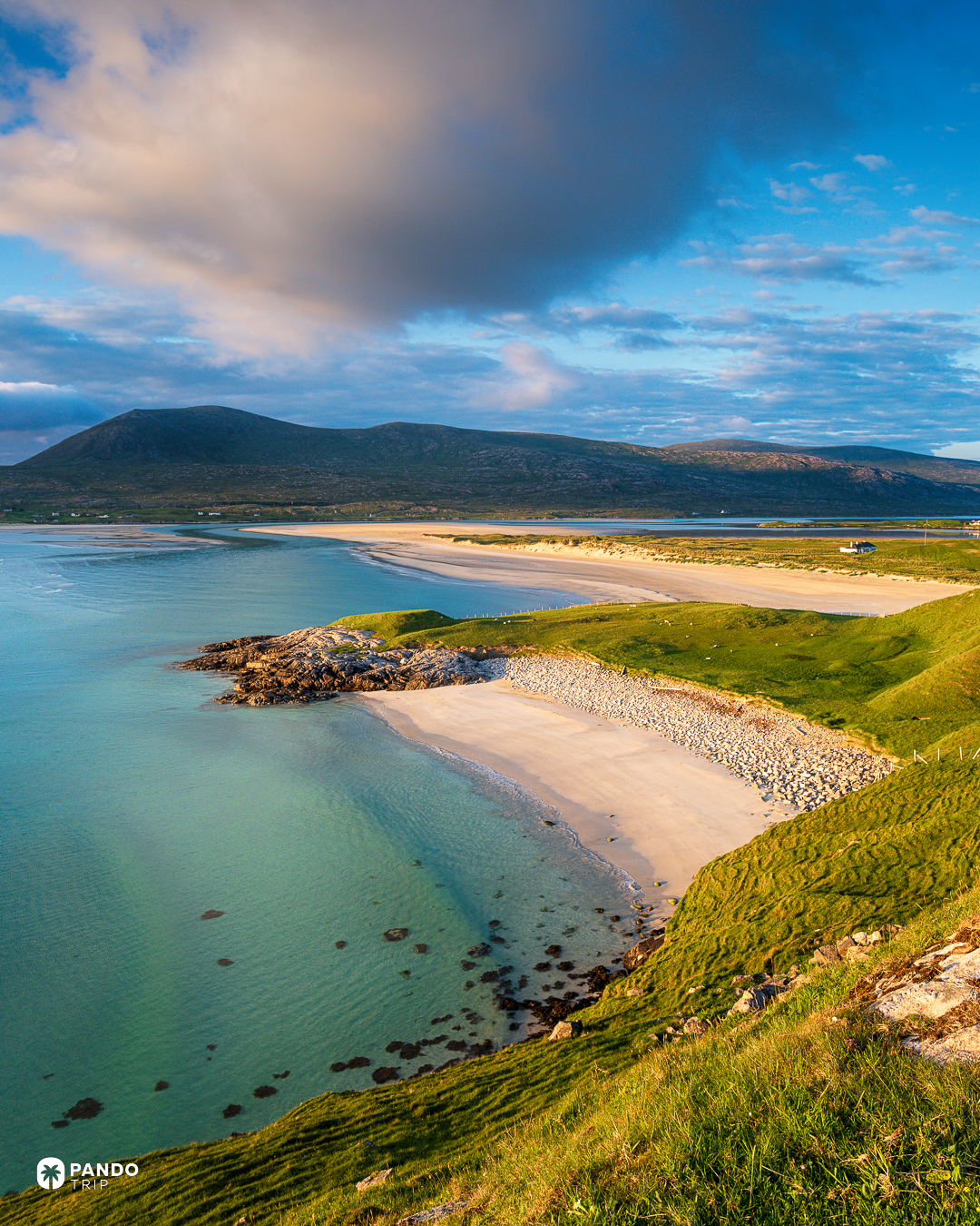 Pale shell sand and turquoise shallows running out towards the hills at Luskentyre, Isle of Harris.